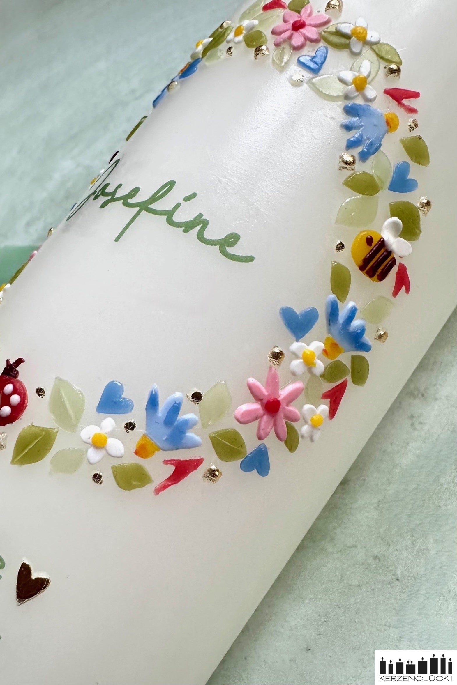 Details von der rechten Seite aufgenommen. Kleine Biene umgeben von hellblauen und rosafarbenen Blüten im Kranz